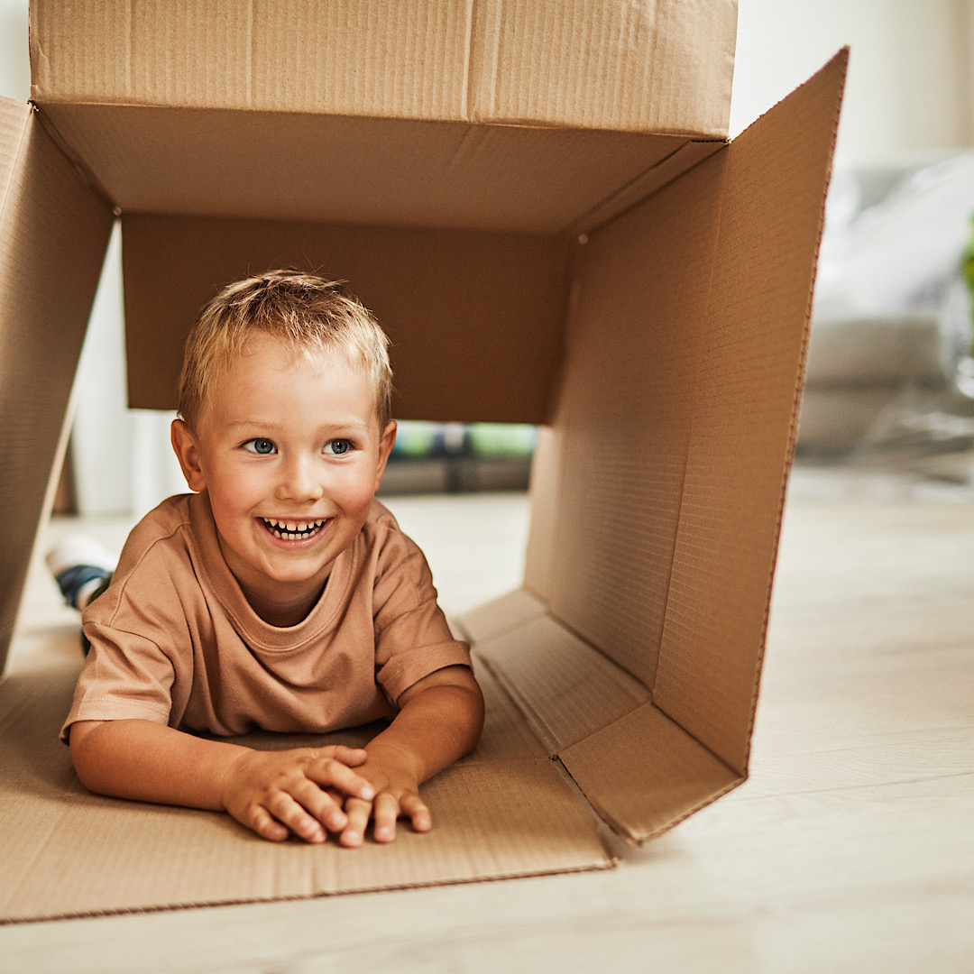 Kids playing in a box while moving in Austin, TX