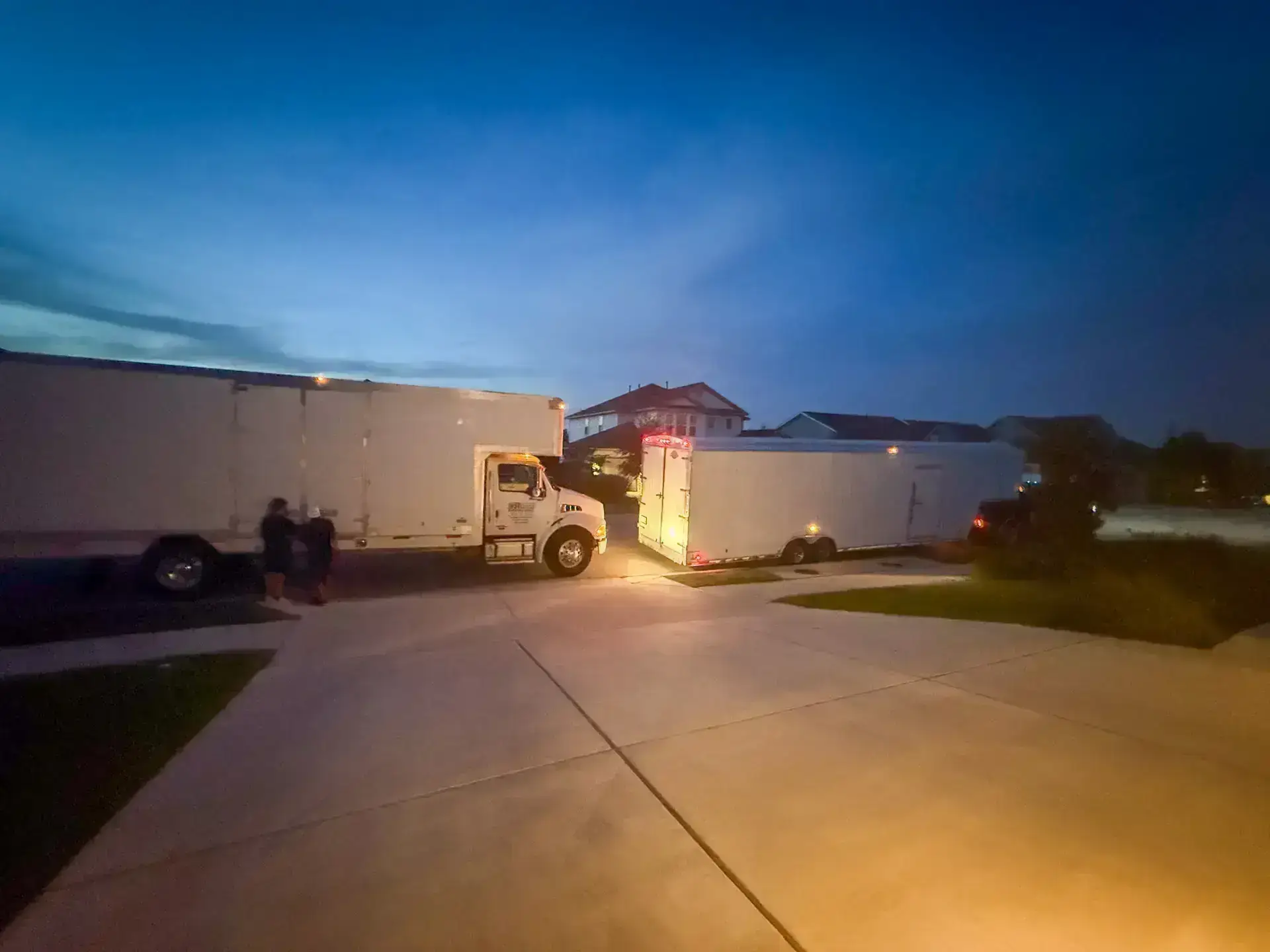First Class moving truck and trailer parked at dusk