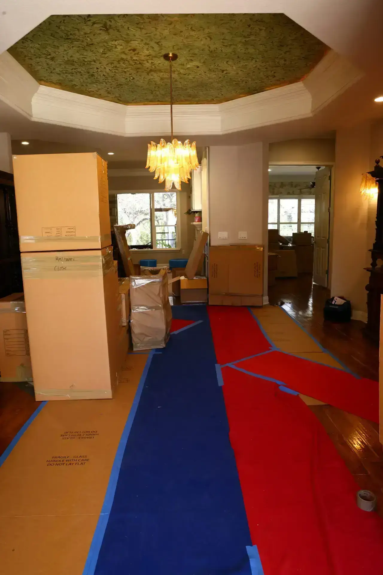 Protective floor runners through a home during moving preparations