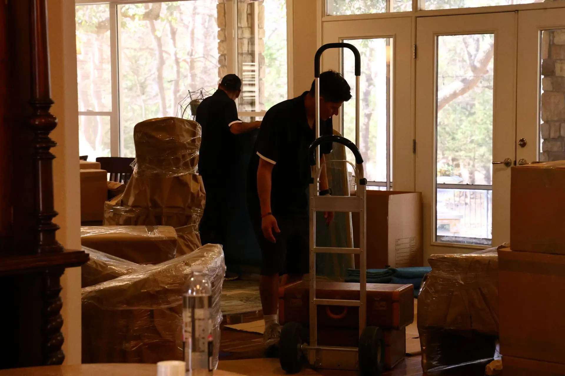 First Class crew preparing belongings inside a home