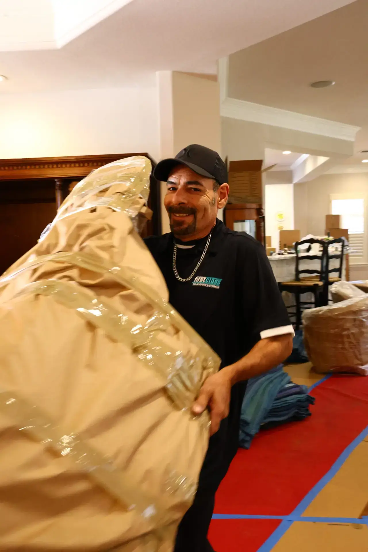 First Class mover handling a wrapped item