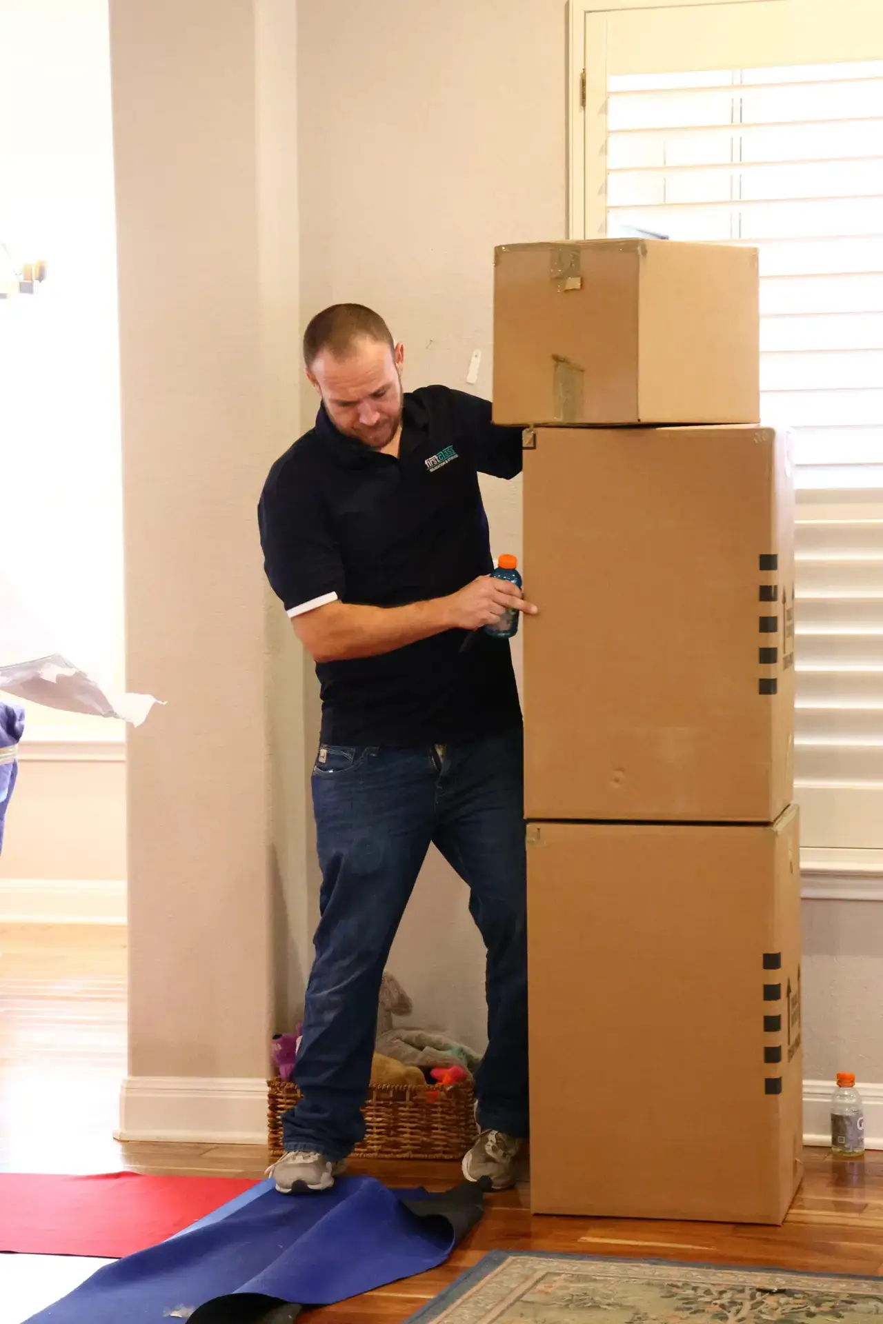 Commercial movers in Austin TX carrying boxes inside moving trailer