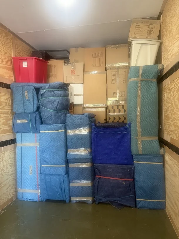 Furniture and boxes organized inside a moving truck